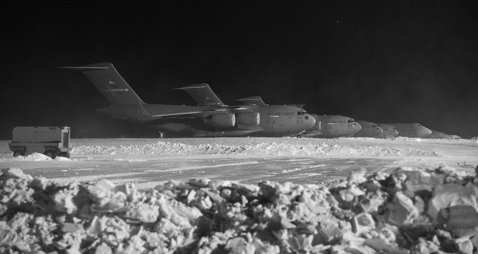C-17A Globemaster IIIs and C-5M Super Galaxies sit on the snow-covered flight line Jan. 5, 2018, at Dover Air Force Base, Del. Eight inches of snow fell at Dover courtesy of Winter Storm Grayson. (U.S. Air Force photo by Roland Balik)