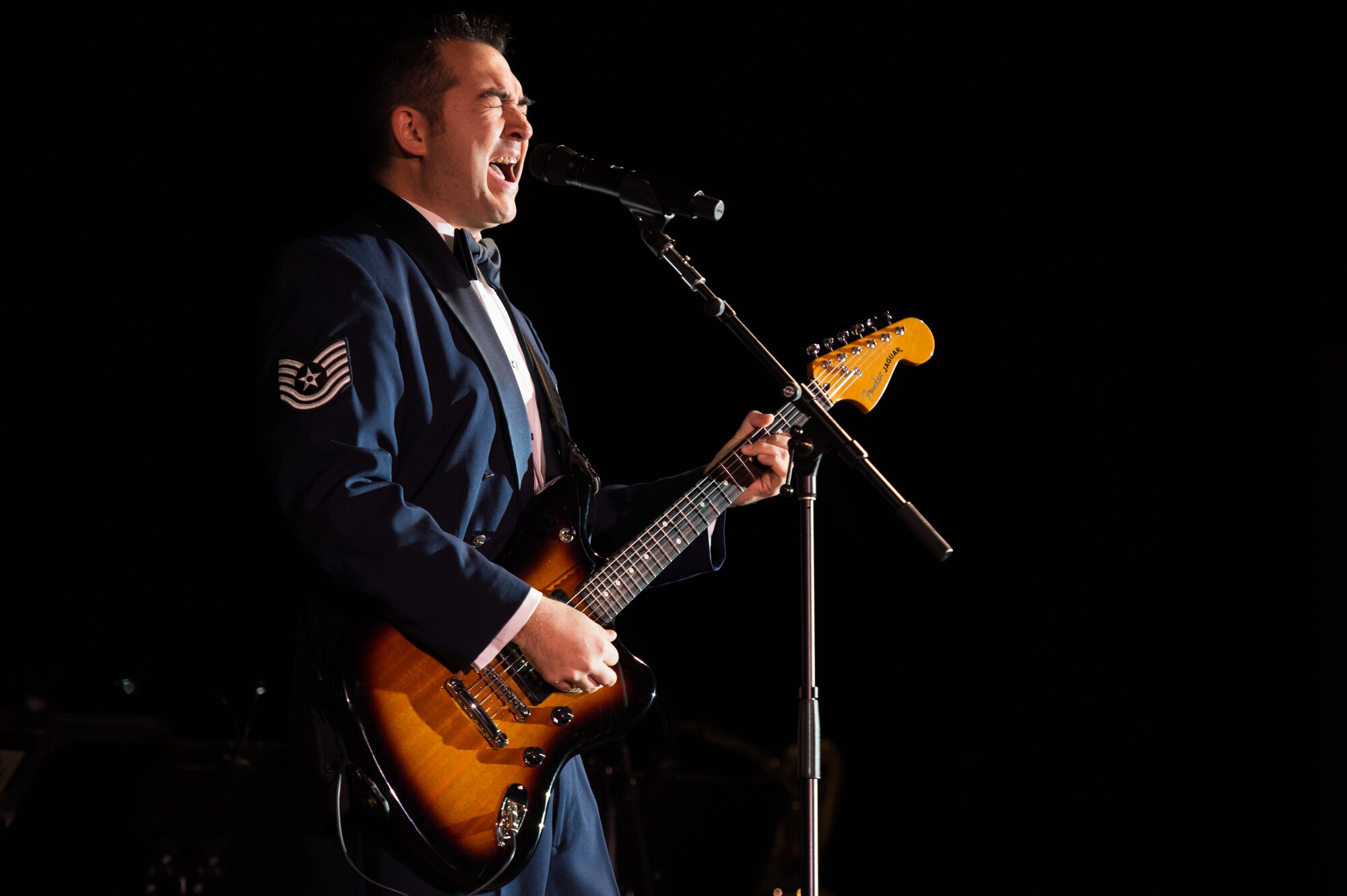 U.S. Air Force Tech. Sgt. Justin Allen, U.S. Air Force Heritage of America Band vocalist, performs a holiday song during the Holiday Memories in Blue concert at Tabb High School in Yorktown, Va., Dec. 6, 2017.