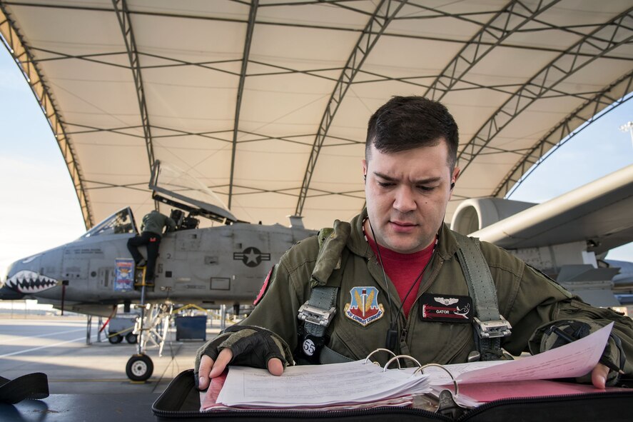 Capt. Haden Fullam, 75th Fighter Squadron pilot, reads a flight plan, Jan. 5, 2018, at Moody Air Force Base, Ga. Team Moody resumed its flying operations after a Jan. 3 snow storm halted all maintenance and flying operations. (U.S. Air Force photo by Airman Eugene Oliver)
