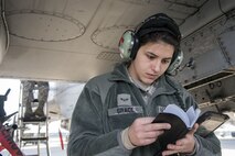 Airman 1st Class Rebecca Grace, 75th Aircraft Maintenance Unit crew chief, flips through a notebook, Jan. 5, 2018, at Moody Air Force Base, Ga. Team Moody resumed its flying operations after a Jan. 4 snow storm halted all maintenance and flying operations. (U.S. Air Force photo by Airman Eugene Oliver)