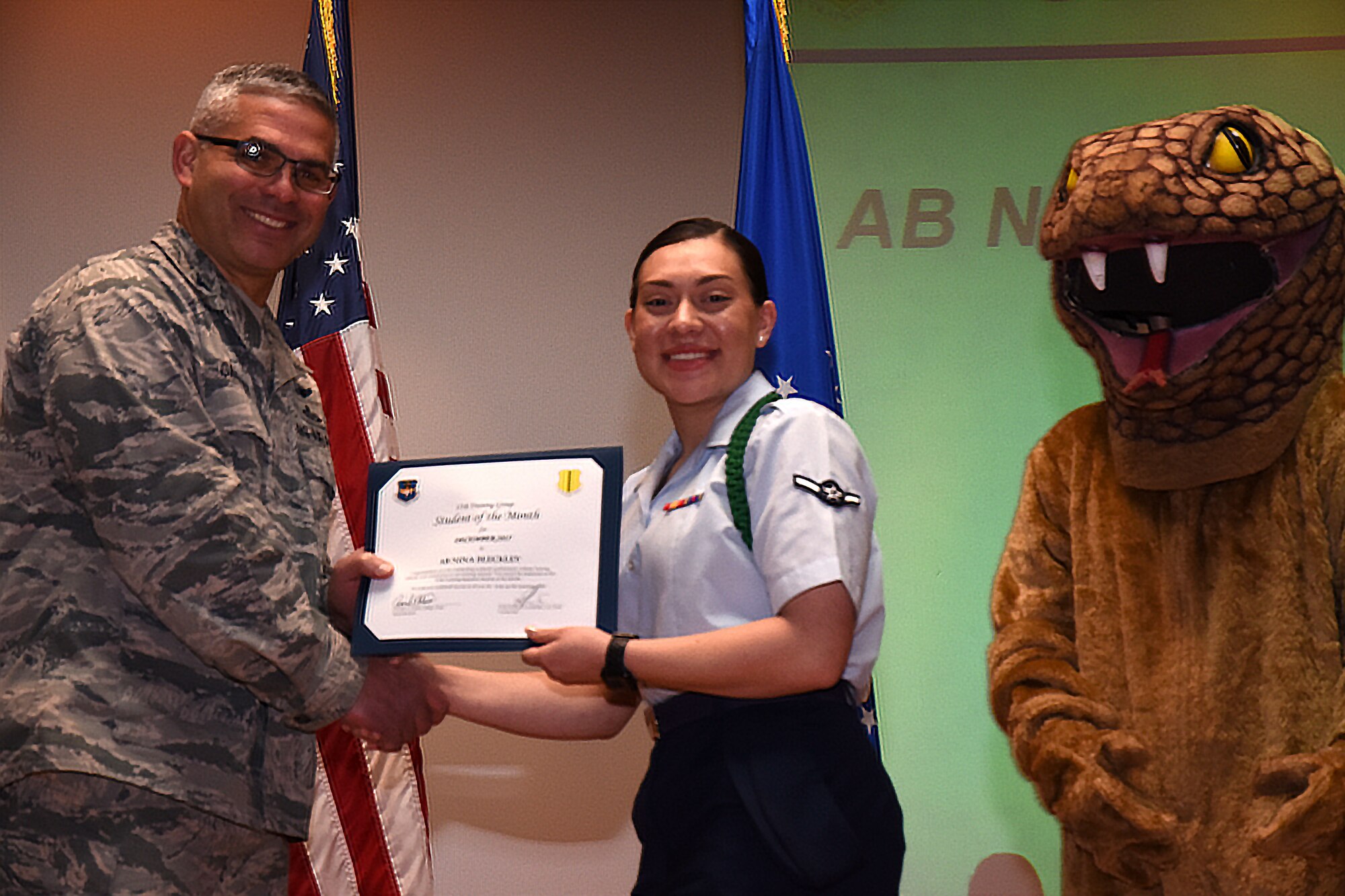 U.S. Air Force Col. Alex Ganster, 17th Training Group commander, presents the 315th Training Squadron Student of the Month award for Dec. 2017 to Airman Nina Bleckley, 315th TRS trainee, in the base theater on Goodfellow Air Force Base, Texas, Jan. 5, 2018. The 315th Training Squadron’s vision is to develop combat-ready intelligence, surveillance and reconnaissance professionals and promote an innovative squadron culture and identity unmatched across the United States Air Force. (U.S. Air Force photo by Airman 1st Class Seraiah Hines/Released)