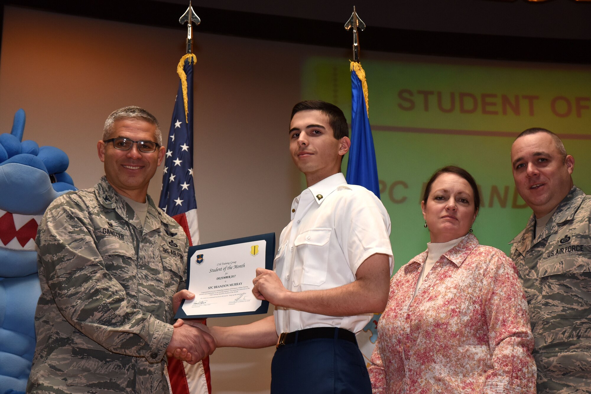 U.S. Air Force Col. Alex Ganster, 17th Training Group commander, presents the 316th Training Squadron Student of the Month award for Dec. 2017 to U.S. Army Spc. Brandon Murray, 316th TRS trainee, in the base theater on Goodfellow Air Force Base, Texas, Jan. 5, 2018. The 316th Training Squadron’s mission is to conduct U.S. Air Force, U.S. Army, U.S. Marine Corps, U.S. Navy and U.S. Coast Guard cryptologic, human intelligence and military training. (U.S. Air Force photo by Airman 1st Class Seraiah Hines/Released)
