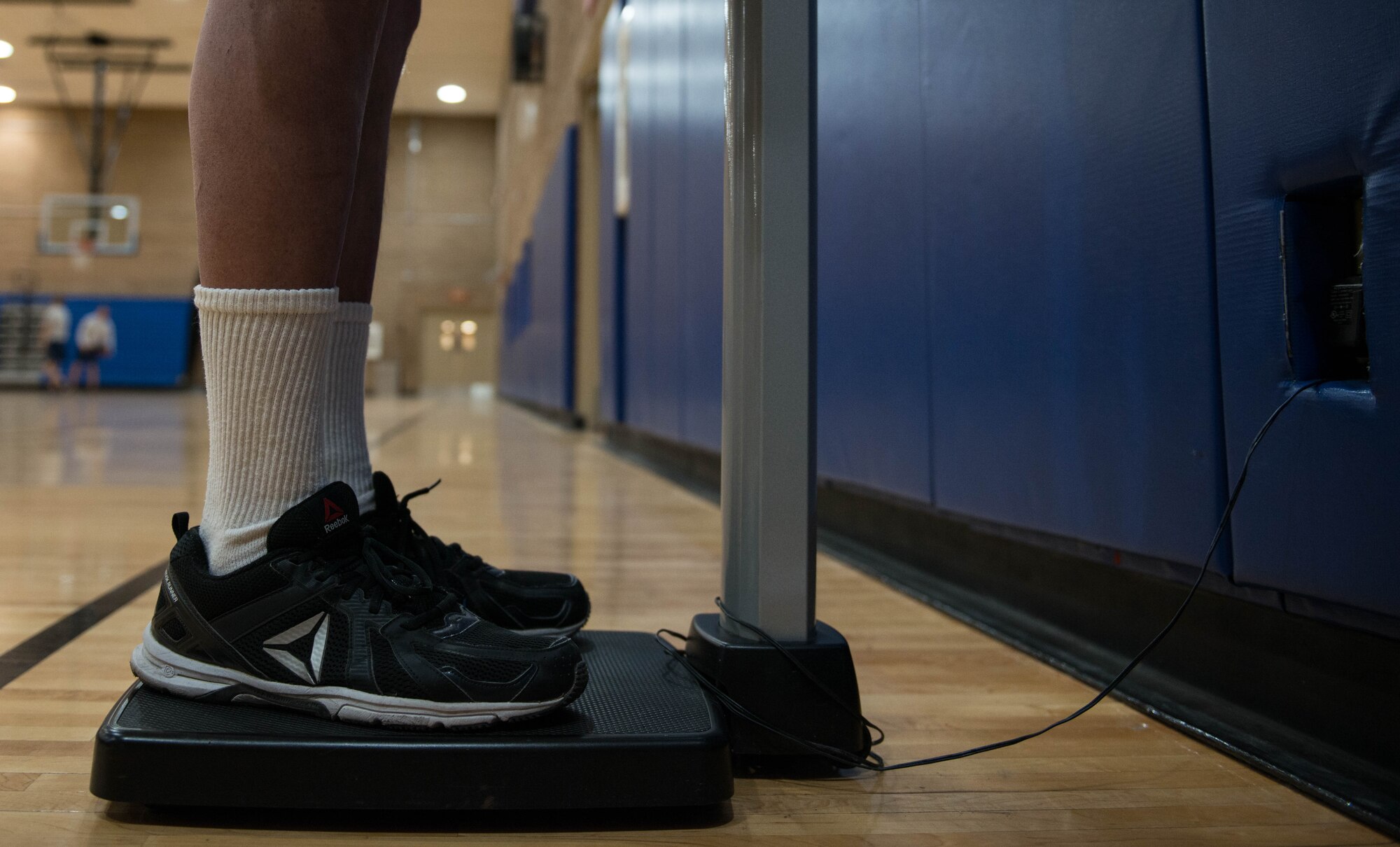 A participant in the “New Year, New You Weight Loss Challenge” stands on a scale at the Bryant Fitness Center Jan. 8, 2018. Throughout the challenge, participants will track their weight and body measurements every two weeks. (U.S. Air Force photo/Airman 1st Class Alexander Cook)
