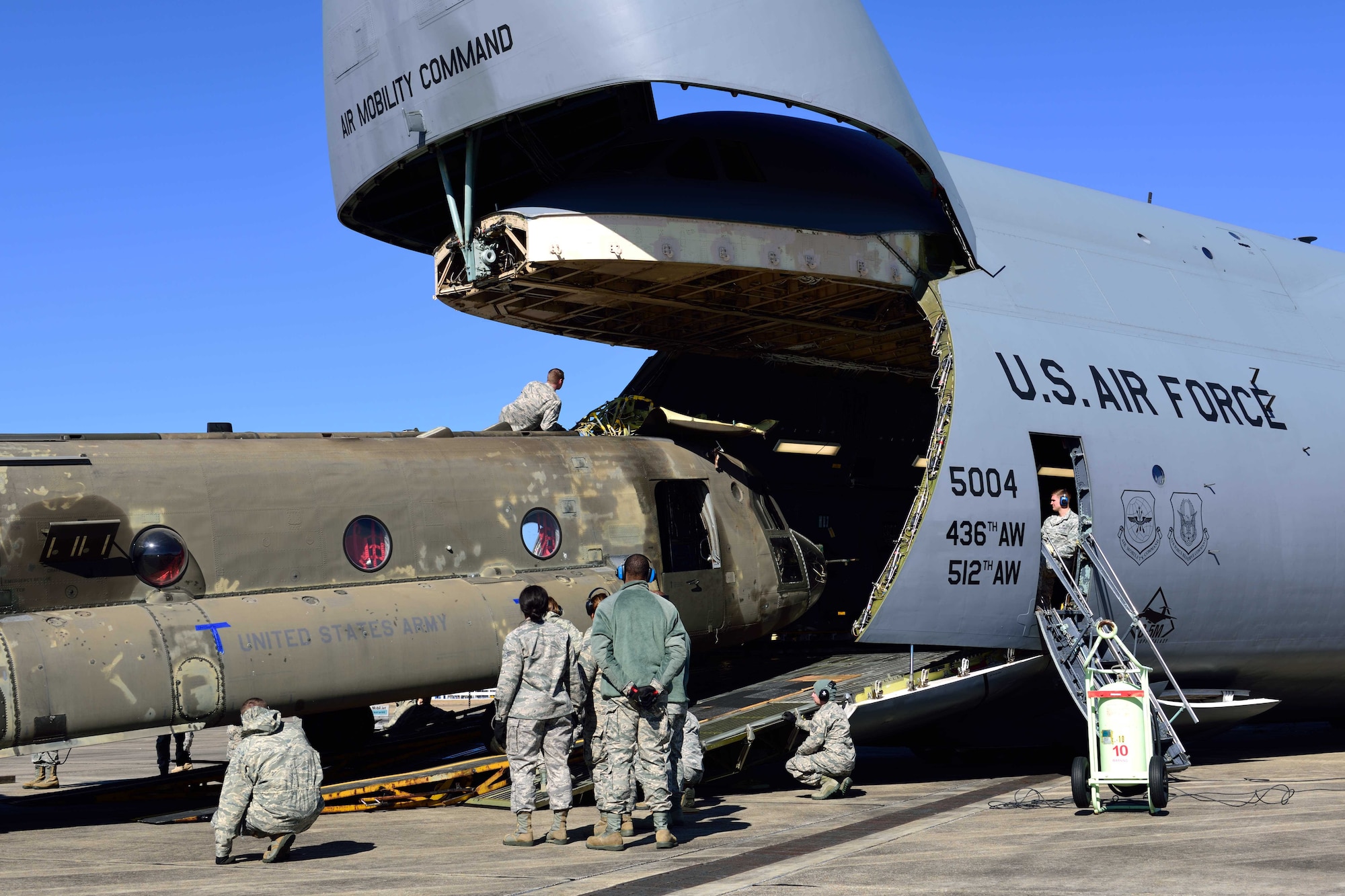 Reservists from the 41st Aerial Port Squadron and other service members from various units load a CH-47 Chinook helicopter onto a C-5M Super Galaxy from the 709th Airlift Squadron at the Gulfport Combat Readiness Training Center – Battlefield Airman Center, Miss., Jan. 6, 2018. Reservists, guardsmen, civilians and active-duty members from the Air Force, Army and Navy worked side by side during this training event called Breaking Barriers GRIP III Jan. 5-7, highlighting the joint effort of this training opportunity. (U.S. Air Force photo by Tech. Sgt. Ryan Labadens)