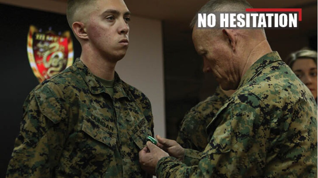 Lt. Gen. Lawrence D. Nicholson, commanding general of III Marine Expeditionary Force, awards Cpl. Matthew Dungan with the Navy and Marine Corps Commendation Medal Jan. 3, 2018 at Camp Courtney, Okinawa, Japan. Dungan, a bulk fuel specialist with Bulk Fuel Company, 9th Engineer Support Battalion (ESB), 3rd Marine Logistics Group, received the award for aiding Master Sgt. Hector Trujillo, a motor transport maintenance chief with 9th ESB, who was injured at the scene of an accident on the Okinawa Expressway Dec. 1, 2017. (U.S. Marine Corps photo by Pfc. Jamin M. Powell)