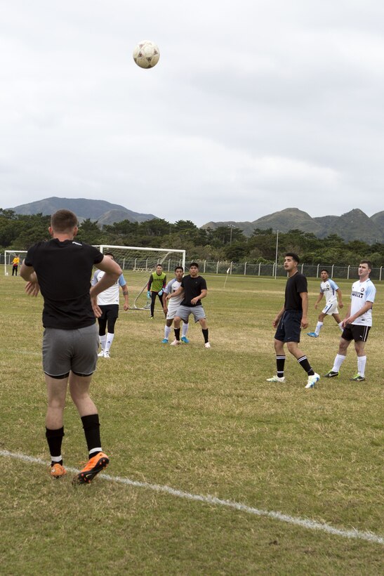 A Marine from team Dirty Dozen throws the ball inbound during a six-on-six soccer tournament Jan. 6 aboard Camp Hansen, Okinawa, Japan. Marine Corps Community Services invited members of the local community to compete against Marines for the first place trophy. Winners from the top three teams were awarded T-shirts and gift cards to any MCCS facility. (U.S. Marine Corps photo by Pfc. Nicole Rogge)