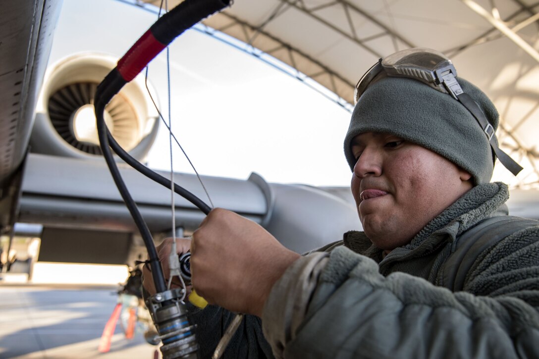 Senior Airman Carlos Ramon-Cruz, 75th Aircraft Maintenance Unit crew chief, connects a radio wire, Jan. 5, 2018, at Moody Air Force Base, Ga. Team Moody resumed its flying operations after a Jan. 3 snow storm halted all maintenance and flying operations. (U.S. Air Force photo by Airman Eugene Oliver)