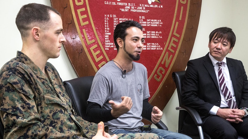 1st Lt. Aaron Cranford speaks in an interview with Justin Kinjo and Yusuke Teruya, divers who almost lost their lives at the hands of a rip current, after the he receives the Navy and Marine Corps Medal on Jan. 8, 2017, at the 3rd Reconnaissance Battalion Headquarters building on Camp Schwab, Okinawa, Japan. Cranford was awarded the Navy and Marine Corps Medal for risking his life while rescuing three divers and a local Okinawan who were caught in rip current during a recreational dive at Onna Point, Okinawa, Japan on April 23, 2017. Cranford, a native of Fort Worth, Texas, is a supply officer with Headquarters and Service Company, 3rd Reconnaissance Battalion, 3rd Marine Division.