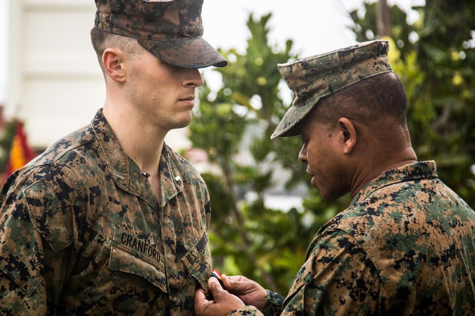 1st Lt. Aaron Cranford receives the Navy and Marine Corps Medal from Maj. Gen. Craig Q. Timberlake, the commanding general for 3rd Marine Division, during an award ceremony on Jan. 8, 2017, at the 3rd Reconnaissance Battalion Headquarters building on Camp Schwab, Okinawa, Japan.