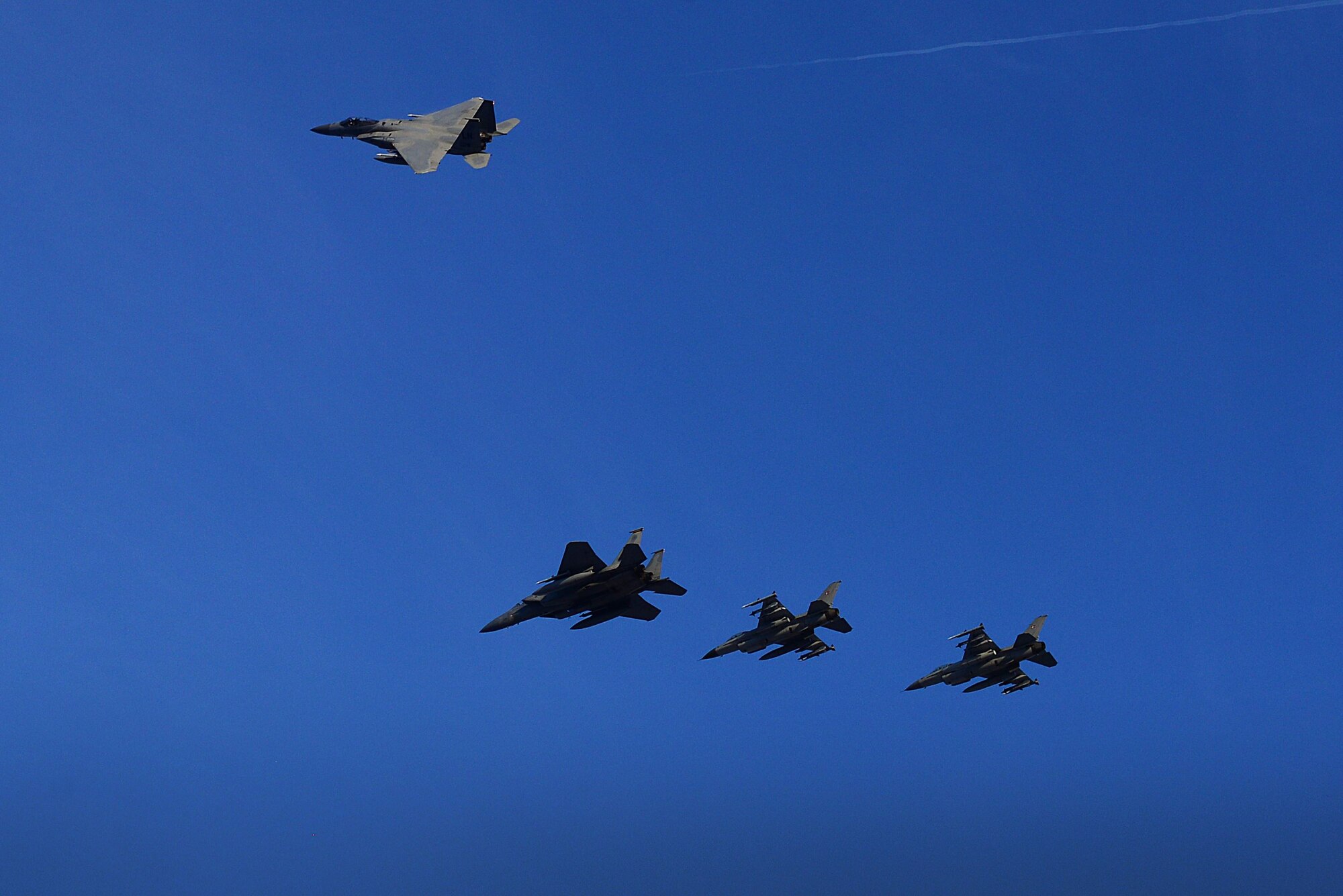 U.S. F-15C Eagles from the 493rd Expeditionary Fighter Squadron peel away from a formation with Royal Danish F-16's to signify the transfer of the NATO Baltic Air Police mission at Siauliai Air Base, Lithuania Jan. 8. NATO Air Policing is a peacetime collective defense mission, safeguarding the integrity of the NATO Alliance member’s airspace. (U.S. Air Force photo/ Tech. Sgt. Matthew Plew)