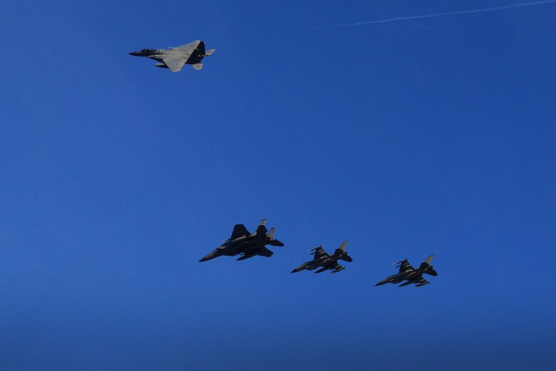 U.S. F-15C Eagles from the 493rd Expeditionary Fighter Squadron peel away from a formation with Royal Danish F-16's to signify the transfer of the NATO Baltic Air Police mission at Siauliai Air Base, Lithuania Jan. 8. NATO Air Policing is a peacetime collective defense mission, safeguarding the integrity of the NATO Alliance member’s airspace. (U.S. Air Force photo/ Tech. Sgt. Matthew Plew)