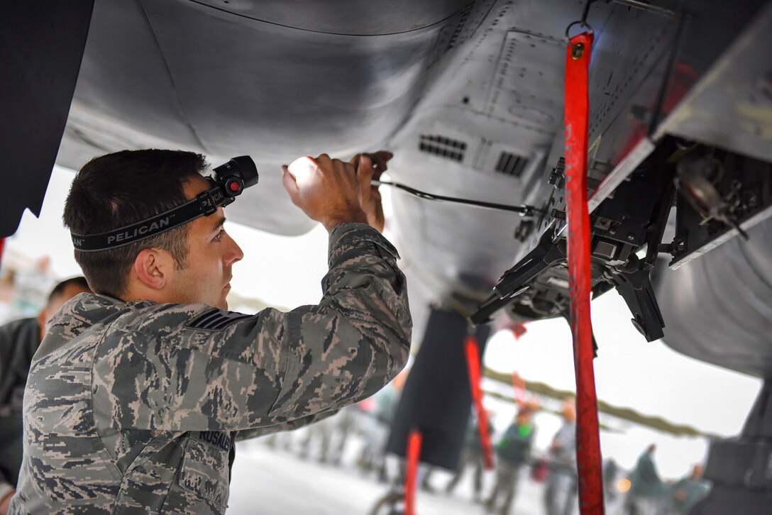 Staff Sgt. Brett Rosales-Carr inspects an F-15 Eagle fighter aircraft.
