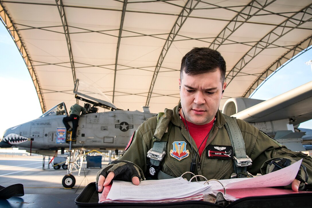 Air Force Capt. Haden Fullam reads a flight plan before taking off on a training mission.