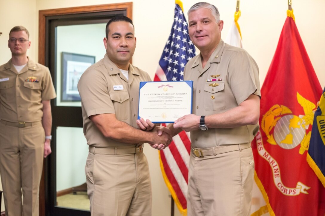 Navy Cdr. Allen “A.J.” Rivera is presented the Meritorious Service Medal for serving as director of Operations Research and Analysis Division at Naval Supply Systems Command, Weapon Systems Support in Mechanicsburg, Pennsylvania, in a ceremony on Jan. 4.