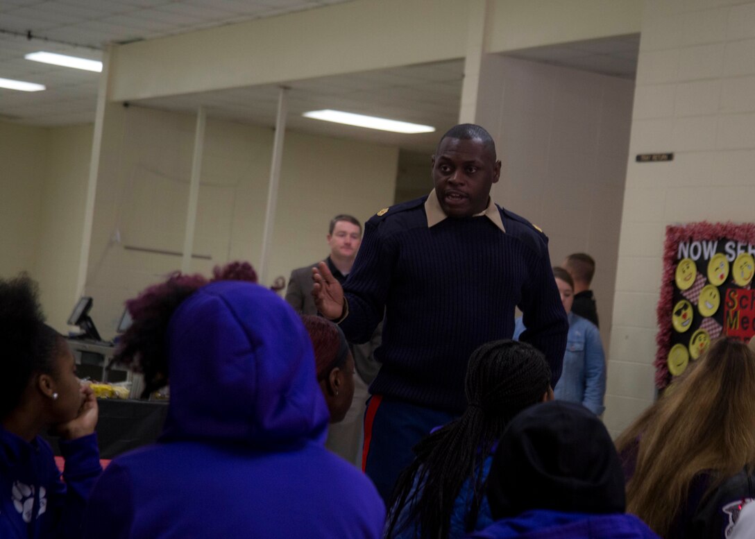 Master Sergeant Damian Cason, the Marine Corps Recruiting Command Engagement Chief, speaks to attendants of the U.S. Marine Corps Ball’N Holiday Invitational at Thompson High School in Alabaster, Alabama, Dec. 29, 2017. The basketball tournament hosts over 50 high schools from across the country. The Marine Corps sponsored the tournament to assist the community in building camaraderie and leadership in the youth. (U.S. Marine Corps photo by Lance Cpl. Jack A. E. Rigsby)