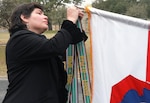 Andrea Gastaldo, U.S. Army North foreign policy advisor, places the Rome-Arno campaign streamer on the unit’s colors during the 75th Anniversary of Fifth Army inside the historic Quadrangle at Joint Base San Antonio-Fort Sam Houston Jan. 5. Andrea is the daughter of Maj. Edward “Eddie” Gastaldo, an Italian-American who fought behind enemy lines as an intelligence officer for Fifth Army headquarters during the Italian Campaign in World War II.