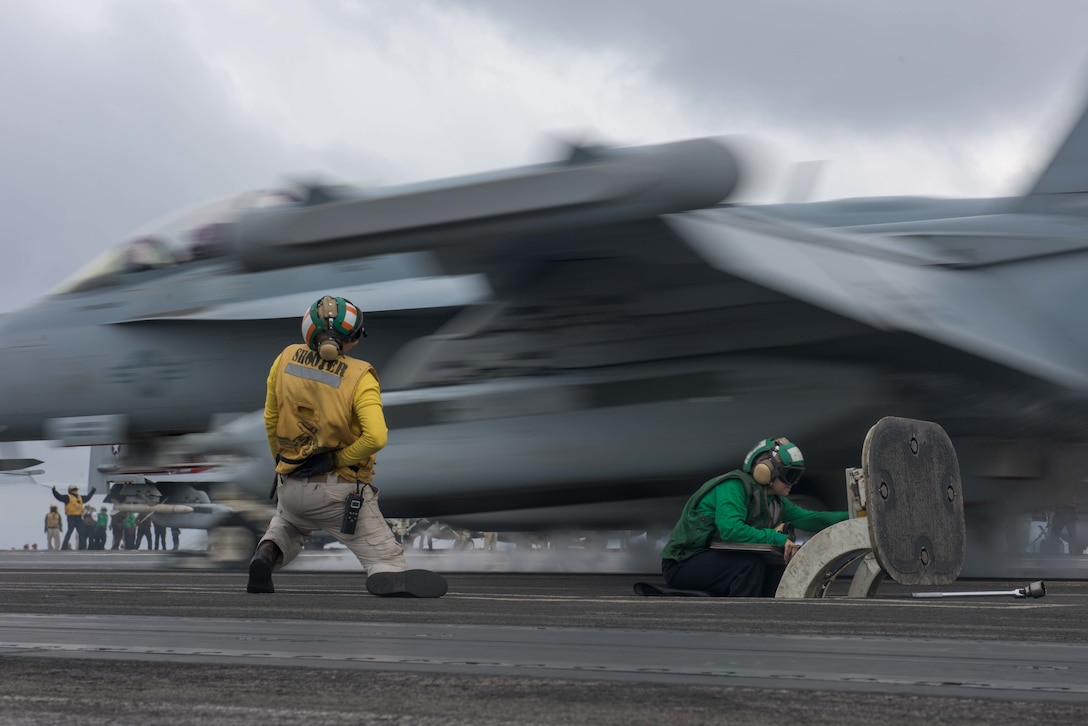 U.S. Navy Airmen signal launch of F/A-18E Super Hornet on flight deck aboard Navy's forward-deployed aircraft carrier USS Ronald Reagan during Carrier Air Wing Five fly-off in Pacific Ocean in waters south of Japan, November 28, 2017 (U.S. Navy/Kenneth Abbate)
