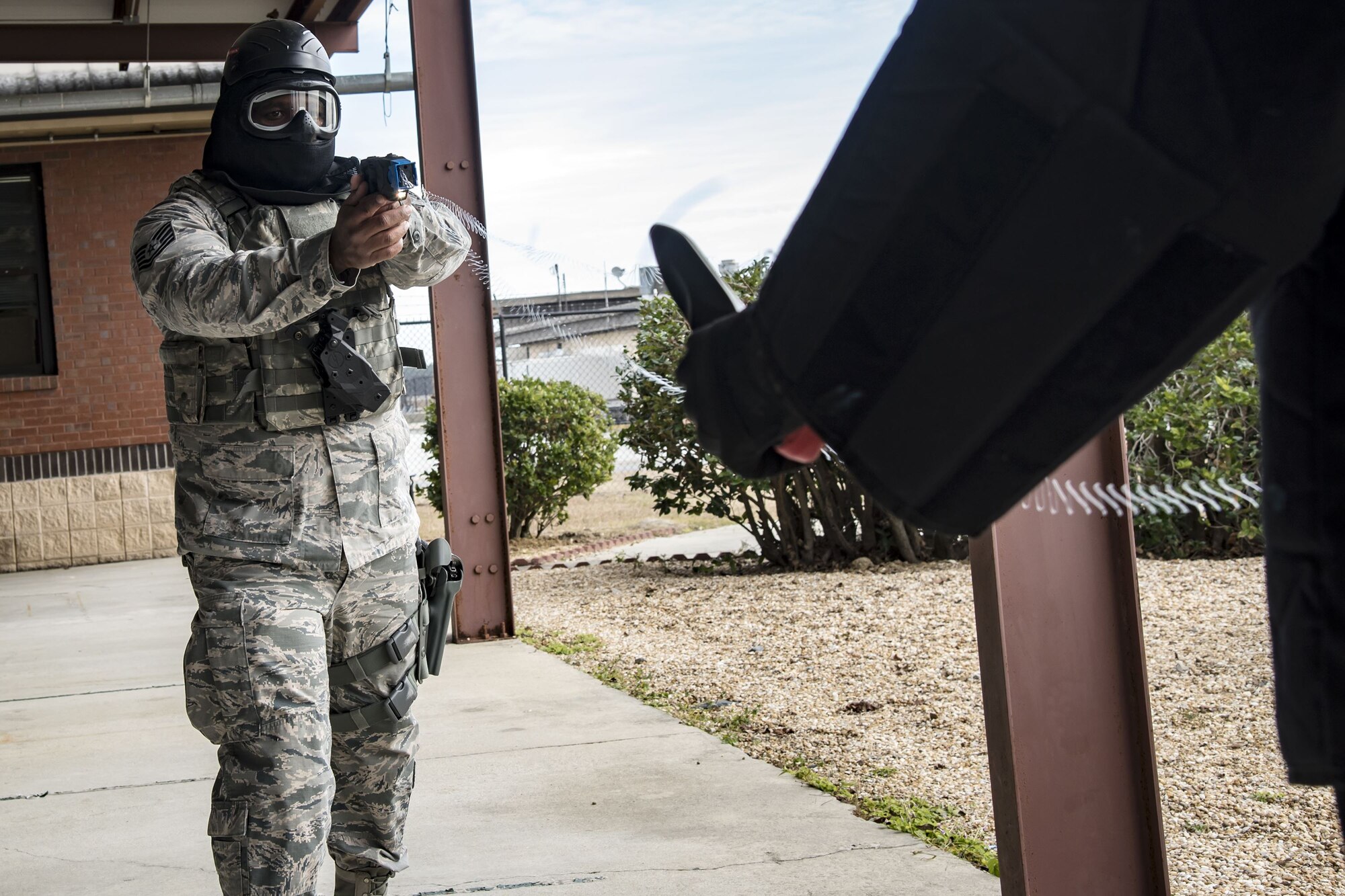 Tech. Sgt. Eddie Ingram III, 23d Security Forces Squadron (SFS) flight sergeant, left, shoots a taser at Senior Airman Brandon Miles, 23d SFS unit trainer, Jan. 8, 2018, at Moody Air Force Base, Ga. The 23d SFS held a “shoot, don’t shoot, engage” training scenario to help prepare their Airmen on how to handle situations in which they have to fire their weapon or simply talk to someone. (U.S. Air Force photo by Airman Eugene Oliver)