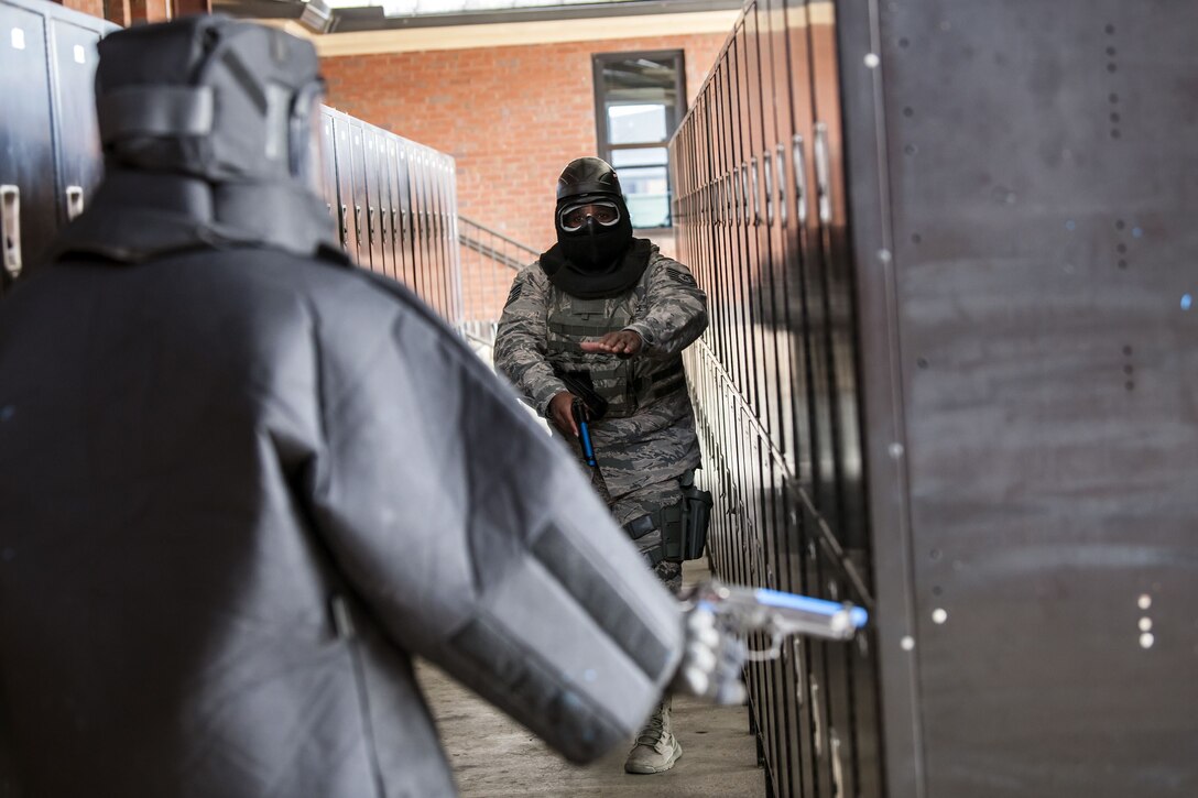 Tech. Sgt. Eddie Ingram III, right, 23d Security Forces Squadron (SFS) flight sergeant, communicates that he wants Senior Airman Brandon Miles, 23d SFS unit trainer to lower his weapon, Jan. 8, 2018, at Moody Air Force Base, Ga. The 23d SFS held a “shoot, don’t shoot, engage” training scenario to help prepare their Airmen on how to handle situations in which they have to fire their weapon or simply talk to someone. (U.S. Air Force photo by Airman Eugene Oliver)
