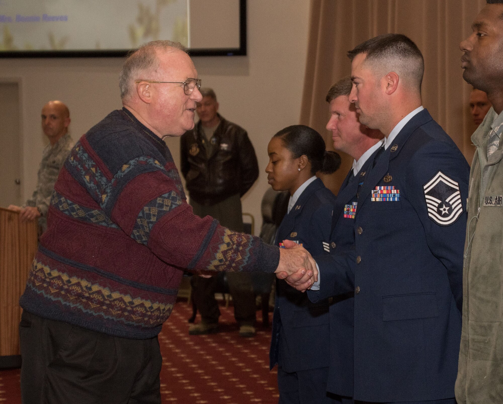 David Lay, a retired U.S. Air Force colonel representing the Shreveport-Bossier Military Affairs Council, congratulates Senior Master Sgt. Ryan Meaux, 307th Maintenance Squadron production section chief, for winning the 307th Bomb Wing Senior Noncommissioned Officer for the fourth quarter of 2017 during a commander’s call on Barksdale Air Force Base, La., Jan. 7, 2018.