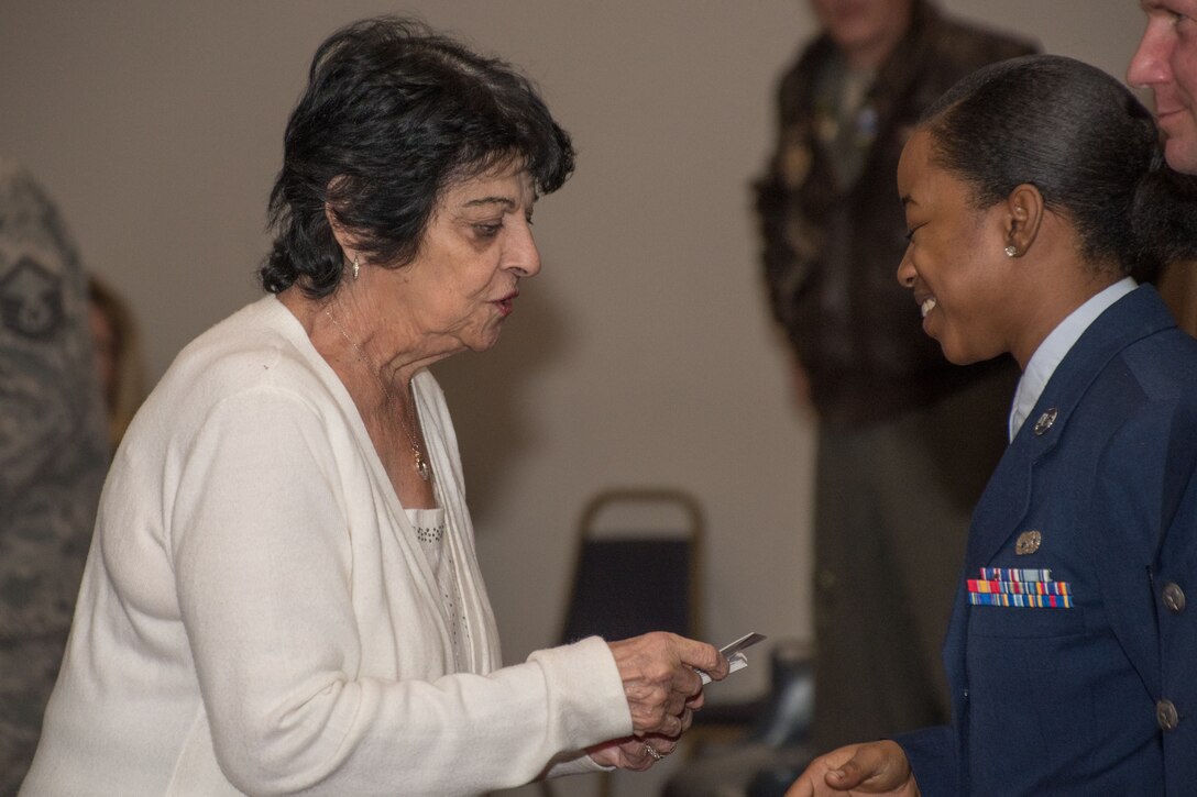 Catherine Vanderberry, a representative of the Bossier Council on aging and the 707th Maintenance Squadron honorary commander, congratulates Senior Airman Destiny Parker, 707th Maintenance Squadron mechanic, for winning the 307th Bomb Wing Airman for the fourth quarter of 2017 during a commander’s call on Barksdale Air Force Base, La., Jan. 7, 2018.