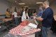 Members of the 167th Operations Group wrap and organize gifts for children in the tri-county area as part of the Ops Adopts program headed up by First Lt. Ryan Day, a pilot for the 167th Airlift Wing, at far right in photo, in the Operations building at the 167th Airlift Wing, Martinsburg, W.Va., Dec. 15. (U.S. Air National Guard photo by Senior Master Sgt. Emily Beightol-Deyerle)