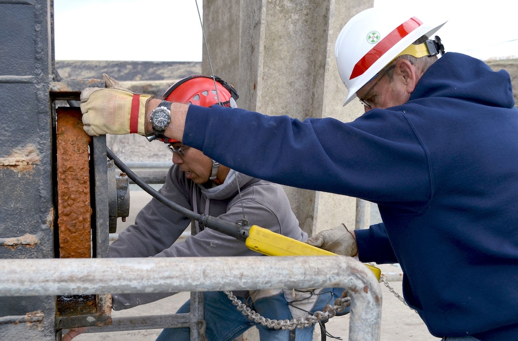Charles Jeung, Engineer for Dam Safety for U.S. Army Corps of Engineers Sacramento District and Randle Goss, Maintenance Mechanic Supervisor for Black Butte Dam work to reseat the bulkhead gate after inspecting it.