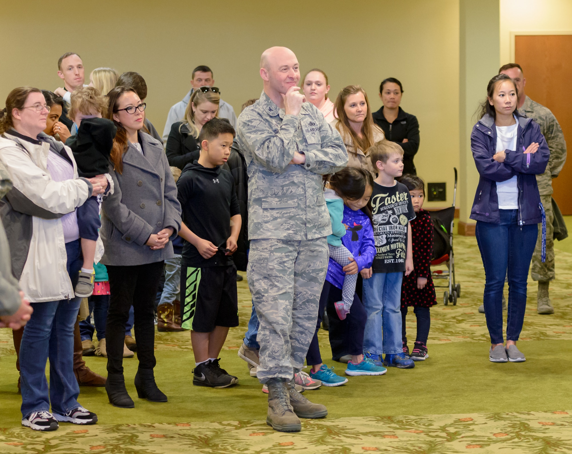 Col. Danny Davis, 81st Mission Support Group commander, listens to opening remarks during the Keesler Play Place Grand Opening ceremony at the Bay Breeze Event Center Jan. 3, 2018, on Keesler Air Force Base, Mississippi. The play place was created after surveying the Keesler community and listening to their feedback in regards to needing an indoor place to go during extreme weather conditions. Included in the area are multiple slides, climbing apparatuses, obstacles and a lounge area. (U.S. Air Force photo by André Askew)