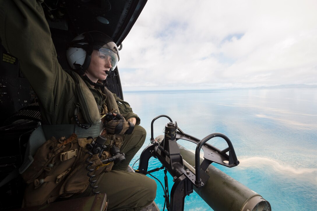 Marine provides tactical navigation assistance to pilots in UH-Y Huey helicopter embarked aboard USS Green Bay, during amphibious raid rehearsal as part of Talisman Saber 17, Coral Sea, July 8, 2017