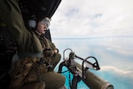Marine provides tactical navigation assistance to pilots in UH-Y Huey helicopter embarked aboard USS Green Bay, during amphibious raid rehearsal as part of Talisman Saber 17, Coral Sea, July 8, 2017