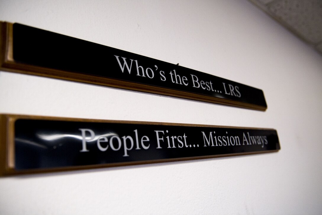 Signs hang from a wall within the 75th Aircraft Maintenance Unit parts checkout section, Jan. 8, 2018, at Moody Air Force Base, Ga. Short’s immersion allowed her to see the processes aircraft parts go through from the time they arrive at Moody to when they’re placed on the aircraft. (U.S. Air Force photo by Senior Airman Daniel Snider)