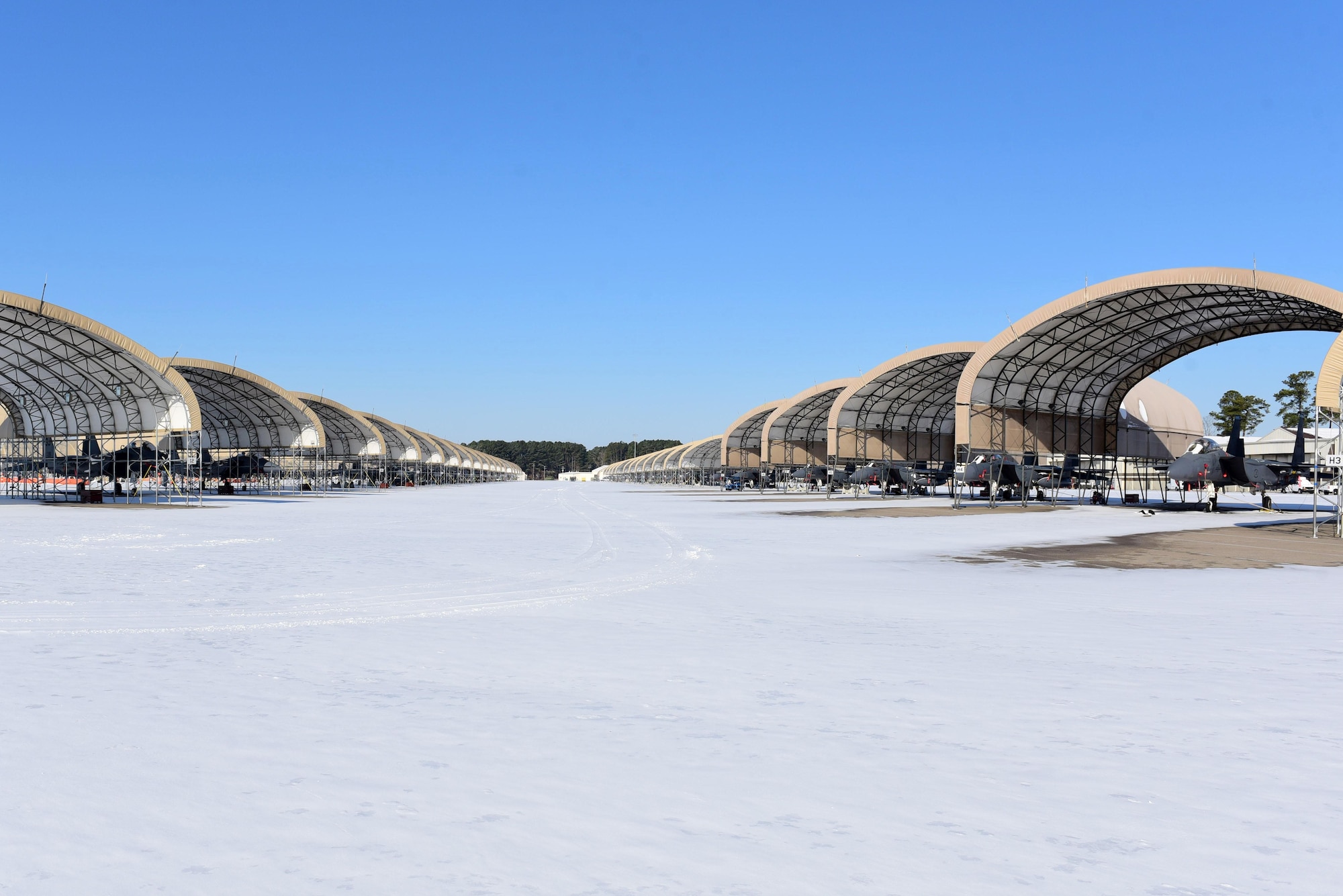 Several F-15E Strike Eagles on a snow covered flight line Jan. 4, 2018, at Seymour Johnson Air Force Base, North Carolina. Seymour Johnson AFB was hit with a snow storm Jan. 3 that dropped several inches of snow over a 12-hour period. (U.S. Air Force photo by Airman 1st Class Victoria Boyton)