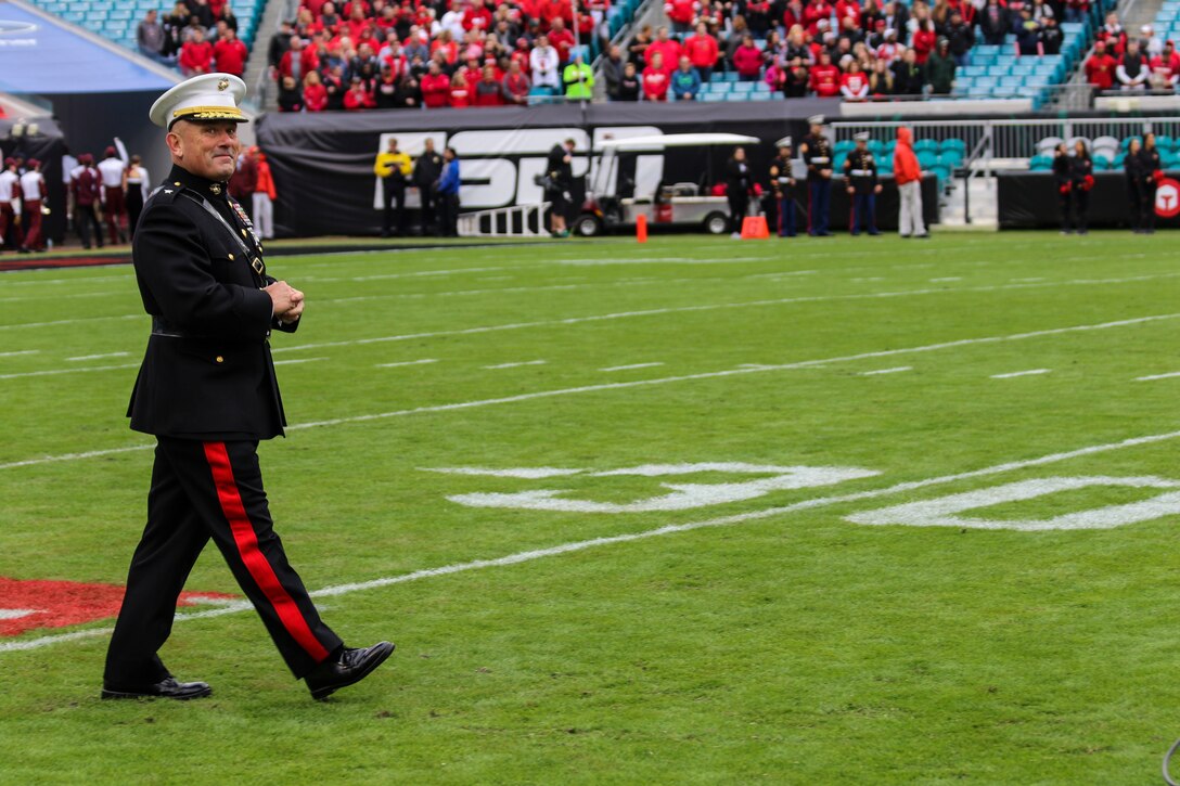 Brigadier General Austin E. Renforth, commanding general of Marine Corps Recruit Depot Parris Island and the Eastern Recruiting Region, walks onto EverBank Field for the coin-toss before the start of the  TaxSlayer Bowl, Dec. 30, 2017, in Jacksonville, Florida. Renforth was invited by the Jacksonville Sports Council to be the guest-of-honor during the game. (U.S. Marine Corps Photo by Sgt. Tony Simmons)