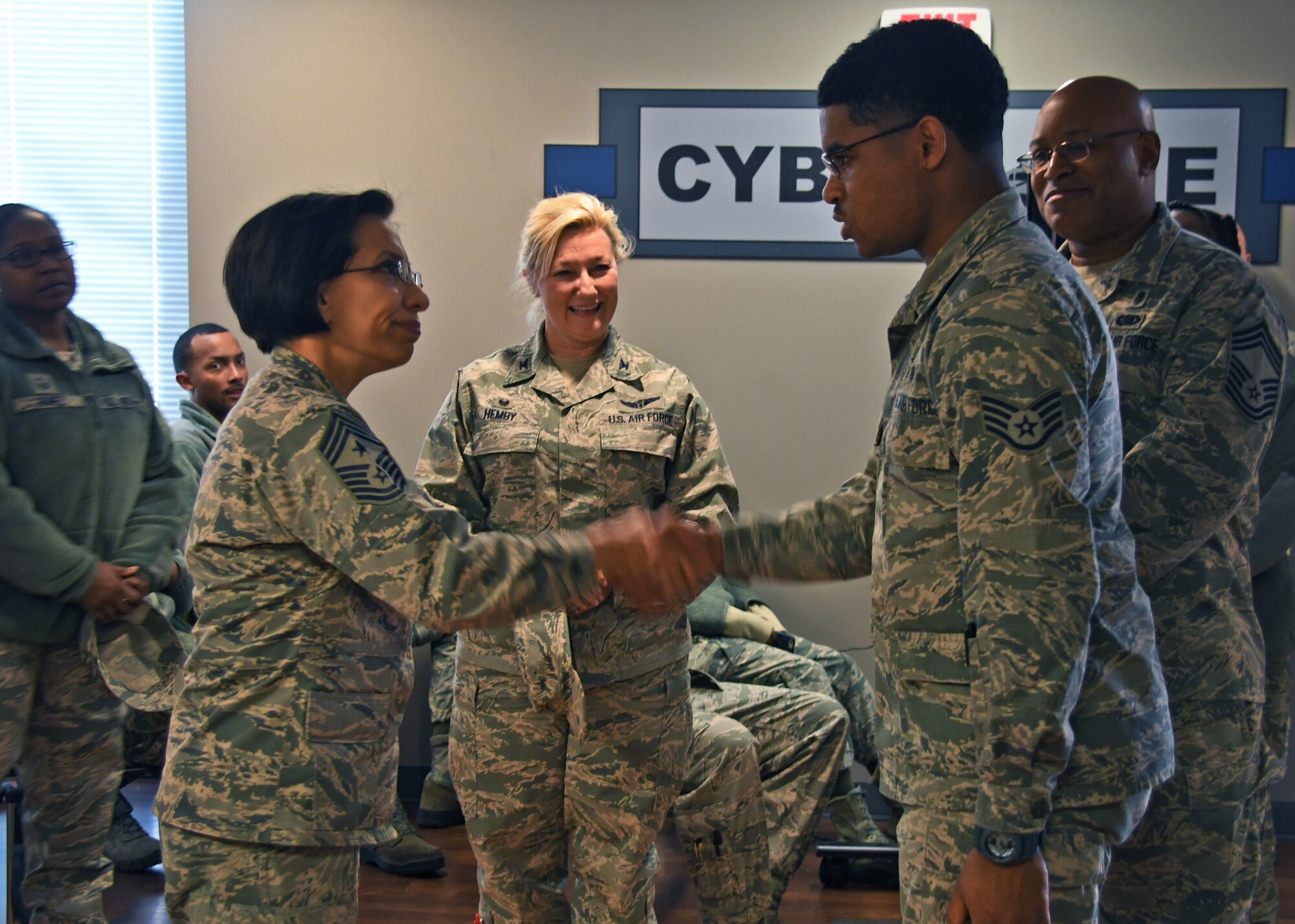 Chief Master Sgt. Ericka Kelly, Air Force Reserve Command command chief master sergeant, presents a coin to a non-commissioned officer from the 94th Aeromedical Staging Squadron  at Dobbins Air Reserve Base, Ga., Jan. 7, 2018. Kelly presented him with a coin for his outstanding achievements at the 94th ASTS. (U.S. Air Force photo by Staff Sergeant Miles Wilson)