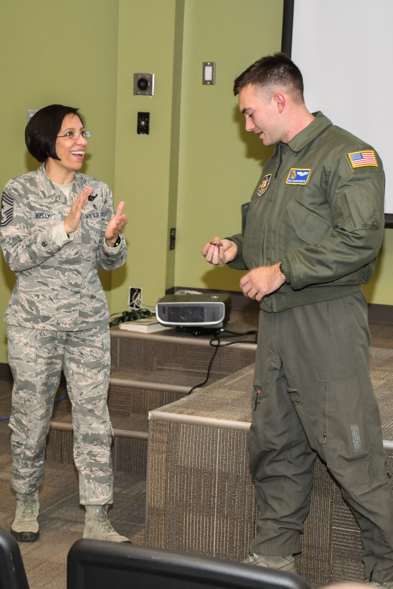 Chief Master Sgt. Ericka Kelly, Air Force Reserve Command command chief master sergeant, coins Senior Airman Caleb Bowlick, a 700th Airlift Squadron loadmaster, at Dobbins Air Reserve Base, Ga, Jan. 7, 2018. Kelly visited Dobbins to tour the base and visit the units, as well as host question and answer sessions. (U.S. Air Force photo by Senior Airman Lauren Douglas)