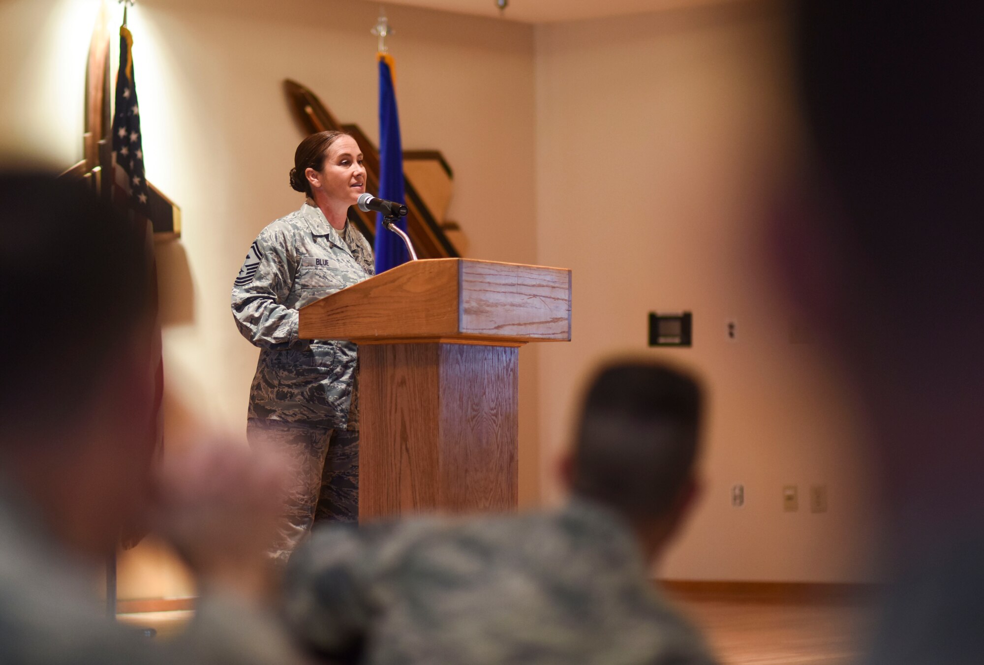 U.S. Air Force Senior Master Sgt. Angela Blue, 1st Maintenance Squadron first sergeant, speaks to Paul. W. Airey NCO Academy students during their graduation Dec. 20, 2017.