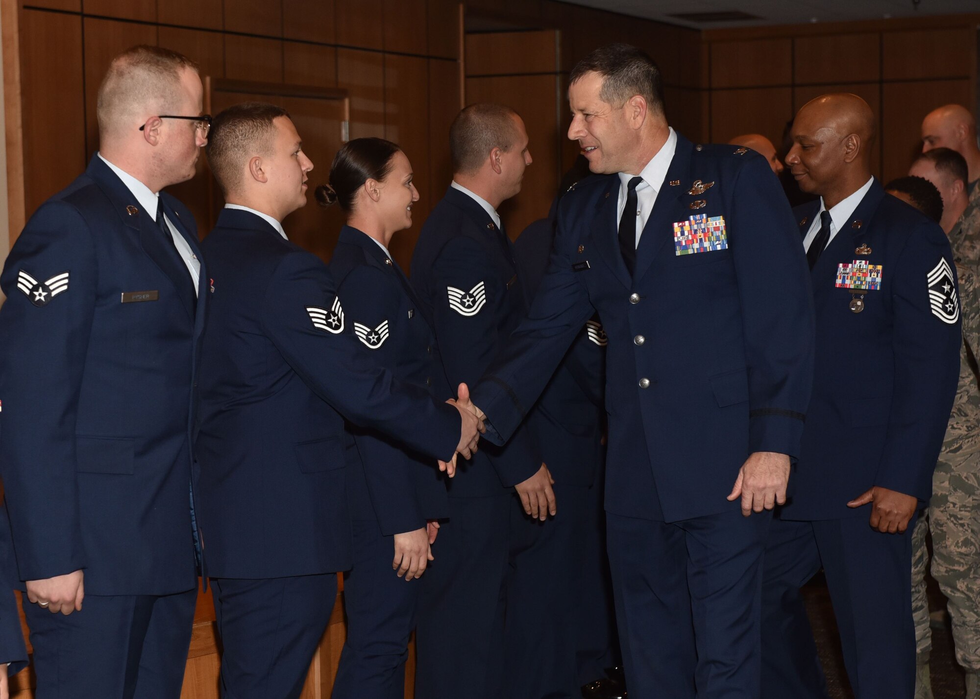U.S. Air Force Col. Michael Hernandez, 325th Fighter Wing commander, congratulates Tyndall’s newest enlisted promotees during the January promotion ceremony at the Horizons Community Center, Jan. 5, 2018. The monthly promotion ceremony honors Airmen receiving a new rank. (U.S. Air Force photo by Senior Airman Sergio Gamboa/Released)