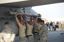 U.S. Air Force colonels load munitions onto an F-15 Eagle during the Chiefs versus Eagles Weapons Loading Competition Jan. 3, 2018, on Kadena Air Base, Japan. Each team had to load one AIM-9X heat seeking missile to the aircraft as quickly as possible. (U.S. Air Force photo by Staff Sgt. Micaiah Anthony)