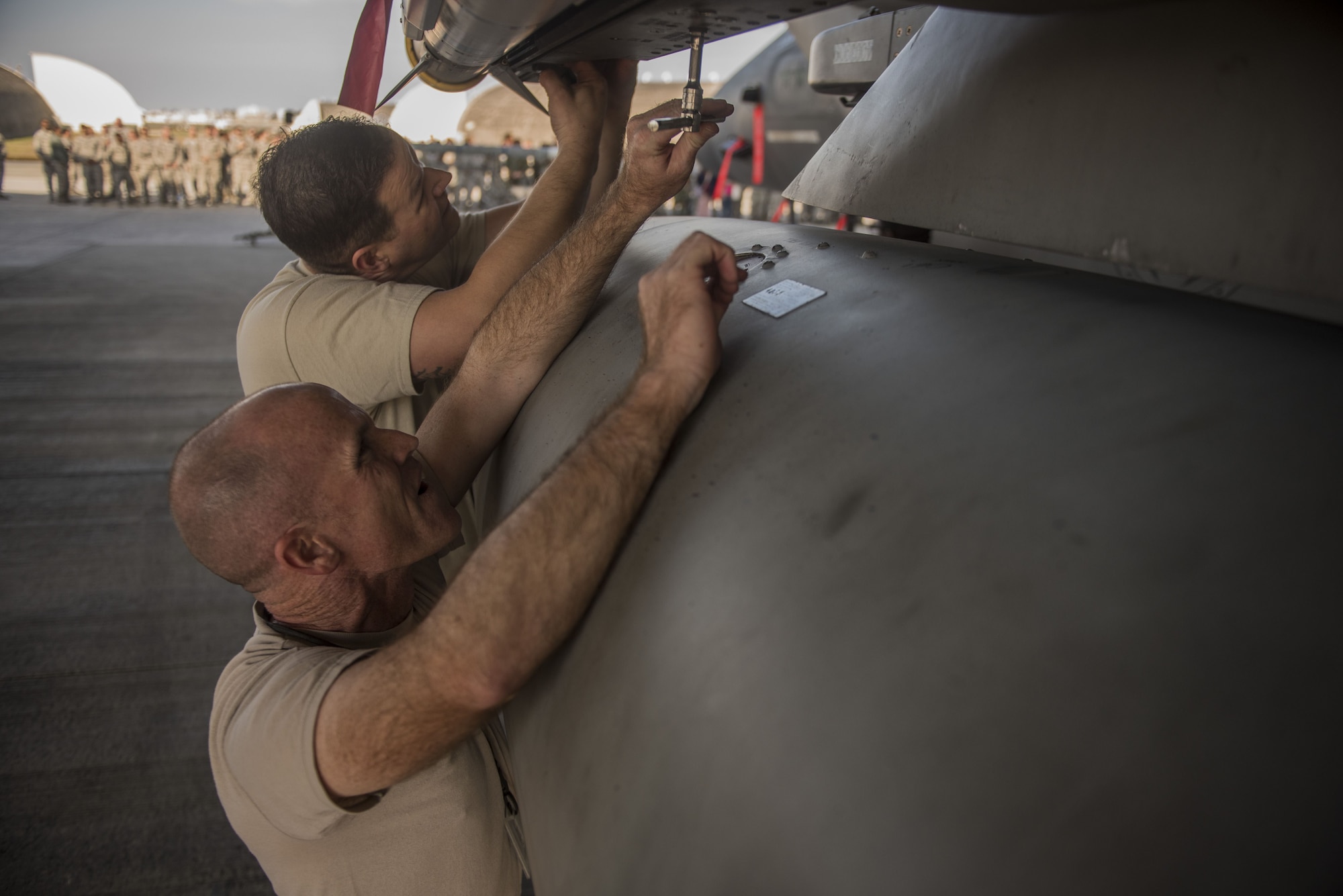U.S. Air Force Chief Master Sgt. Daniel Taylor, front, 18th Maintenance Group superintendent and Chief Master Sgt. Edward Fitzgerald, 18th Civil Engineer Group superintendent, load an AIM-9X heat seeking missile onto an F-15 Eagle during the Chiefs versus Eagles Weapons Load Competition Jan. 3, 2018, on Kadena Air Base, Japan. The competition was held before an annual weapons loading competition where the top teams from the 44th and 67th Aircraft Maintenance Units competed for the title of best weapons load team. (U.S. Air Force photo by Staff Sgt. Micaiah Anthony)