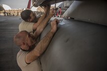 U.S. Air Force Chief Master Sgt. Daniel Taylor, front, 18th Maintenance Group superintendent and Chief Master Sgt. Edward Fitzgerald, 18th Civil Engineer Group superintendent, load an AIM-9X heat seeking missile onto an F-15 Eagle during the Chiefs versus Eagles Weapons Load Competition Jan. 3, 2018, on Kadena Air Base, Japan. The competition was held before an annual weapons loading competition where the top teams from the 44th and 67th Aircraft Maintenance Units competed for the title of best weapons load team. (U.S. Air Force photo by Staff Sgt. Micaiah Anthony)