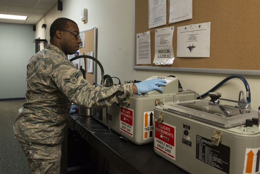 Airman 1st Class Jemal Ford, an aircrew flight equipment journeyman with the 3rd Operations Support Squadron, tests the operability of aircrew equipment at Joint Base Elmendorf-Richardson, Alaska, Jan. 5, 2018. AFE Airmen are responsible for maintaining, inspecting and servicing all equipment aircrew require while performing their duties.