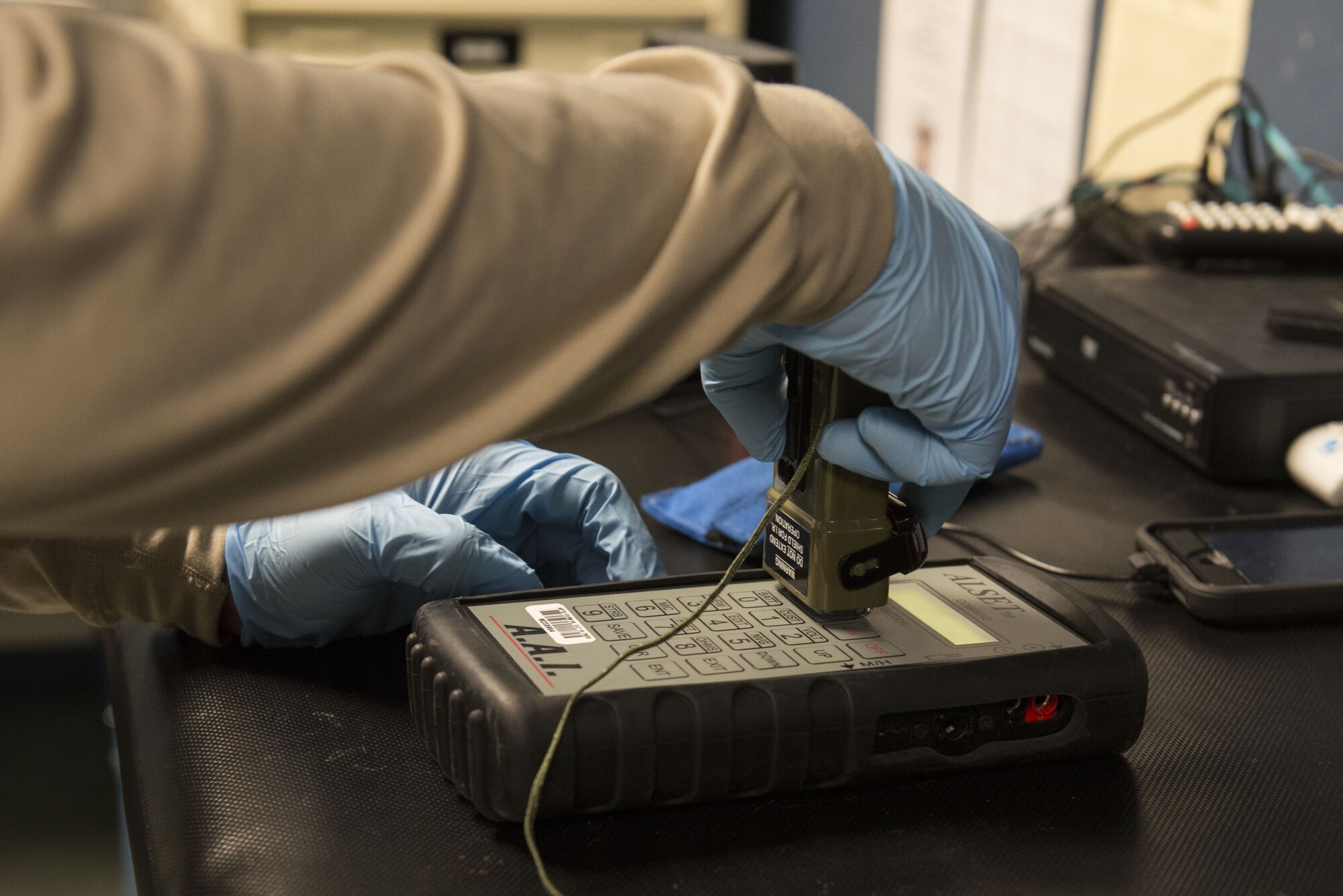 Airman 1st Class Conner Scott, an aircrew flight equipment journeyman with the 3rd Operations Support Squadron, tests the power of a survival strobe light at Joint Base Elmendorf-Richardson, Alaska, Jan. 5, 2018. The survival strobe light offers retractable infared-beacon and regular-light capabilities.