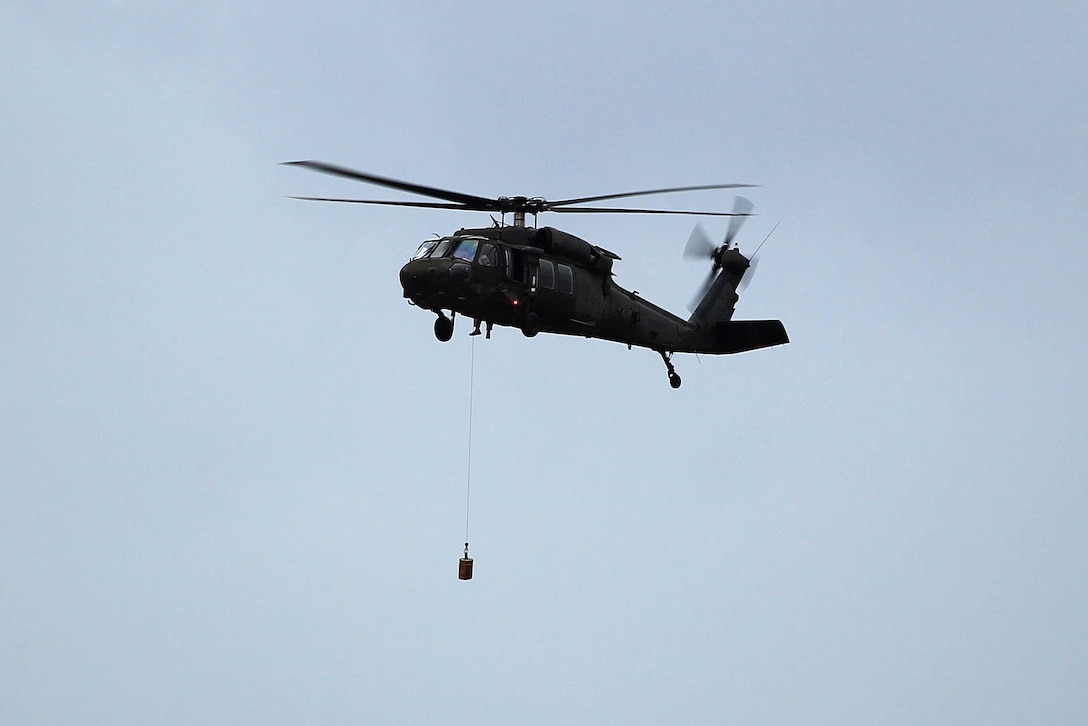 A California Army National Guard UH-60 Black Hawk helicopter tests its rescue hoist system.