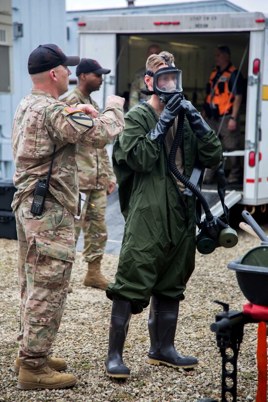 Army Reserve soldiers put on their gear before training.