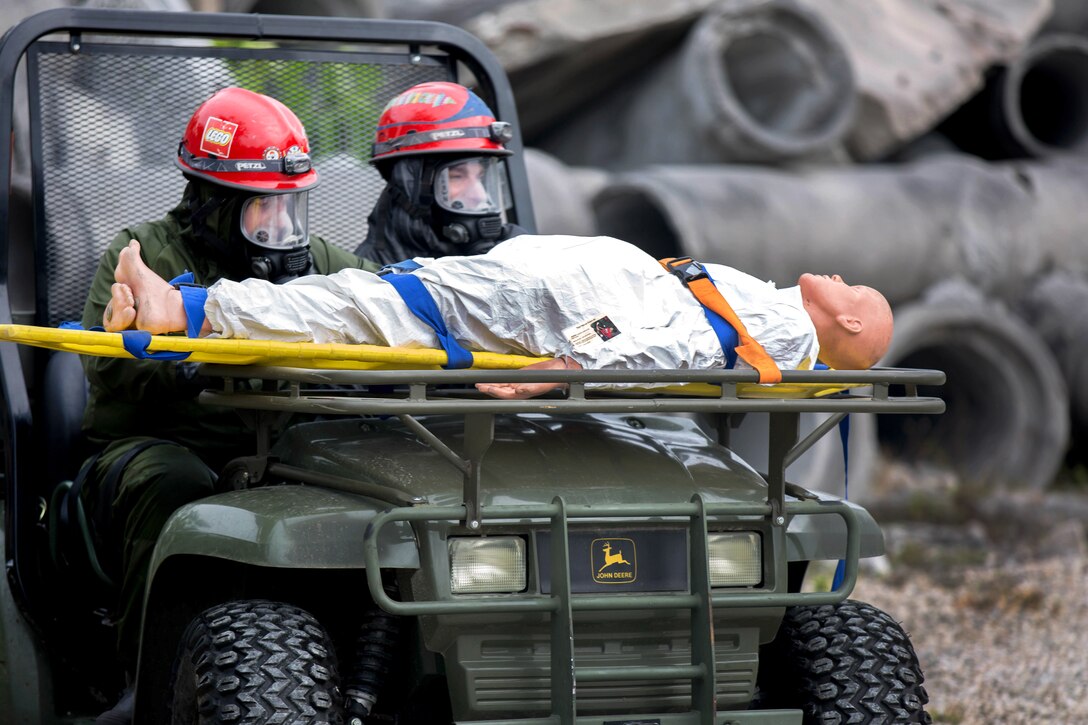Army Reserve soldiers operate an all-terrain vehicle to transport a mock casualty during training.