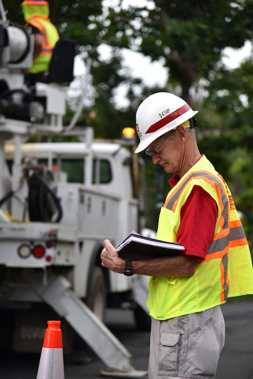 U.S. Army Corps of Engineers Task Force Power Restoration Safety Manager Bill Pioli, of Buffalo District, Buffalo, New York, goes over a Traffic Control Zone checklist while observing a MasTec crew at work in Naranjito, Puerto Rico, Jan. 6. Pioli and the task force safety team conducted an island-wide Traffic Control Zone Intervention to reduce the risk of traffic mishaps for electrical grid restoration teams working to restore power in Puerto Rico.