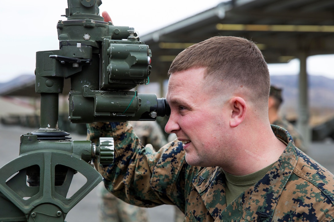 A Marine aligns the sights of an M777 towed 155 mm howitzer as part of a fire control alignment at Marine Corps Base Camp Pendleton, Calif.