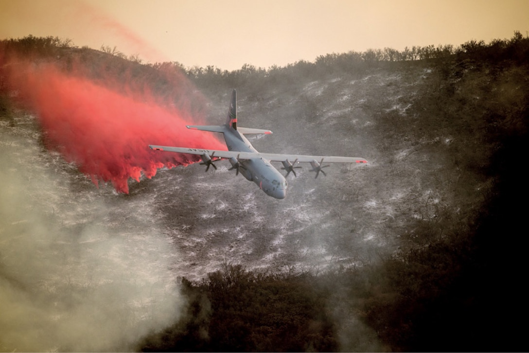 A U.S. Air National Guard C-130J Hercules aircraft equipped with the MAFFS 2 (Modular Airborne Fire Fighting System) drops a line of fire retardant on the Thomas Fire in the hills above the city of Santa Barbara, California, Dec. 13, 2017. The 146th Airlift Wing has been supporting CAL FIRE’s efforts to battle the Thomas Fire raging in Southern California.