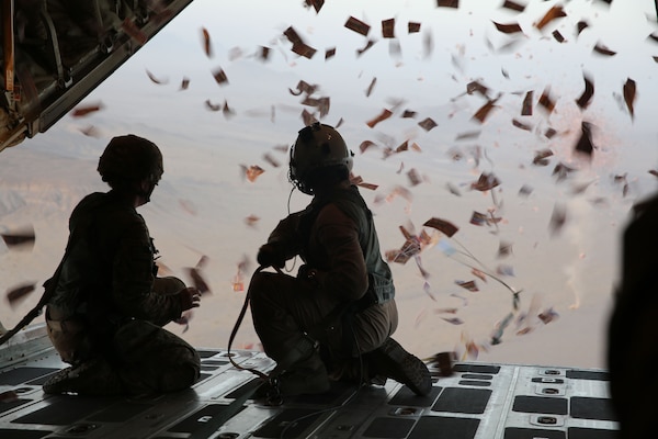 U.S. Army Sgt. Lisa Swan, left, psychological specialist with 303rd psychological operations company (303rd POCO), and U.S. Marine Corps Sgt. Joseph Szombathelyi, right, load master with Marine Aerial Refueler Transport Squadron 252 (VMGR-252), watch leaflets fall off of a KC-130 Super Hercules over southern Afghanistan, Aug. 28, 2013. Leaflets were dropped in support of operations to defeat insurgency influence in the area. (U.S. Marine Corps photo by Sgt. Demetrius Munnerlyn/Released)