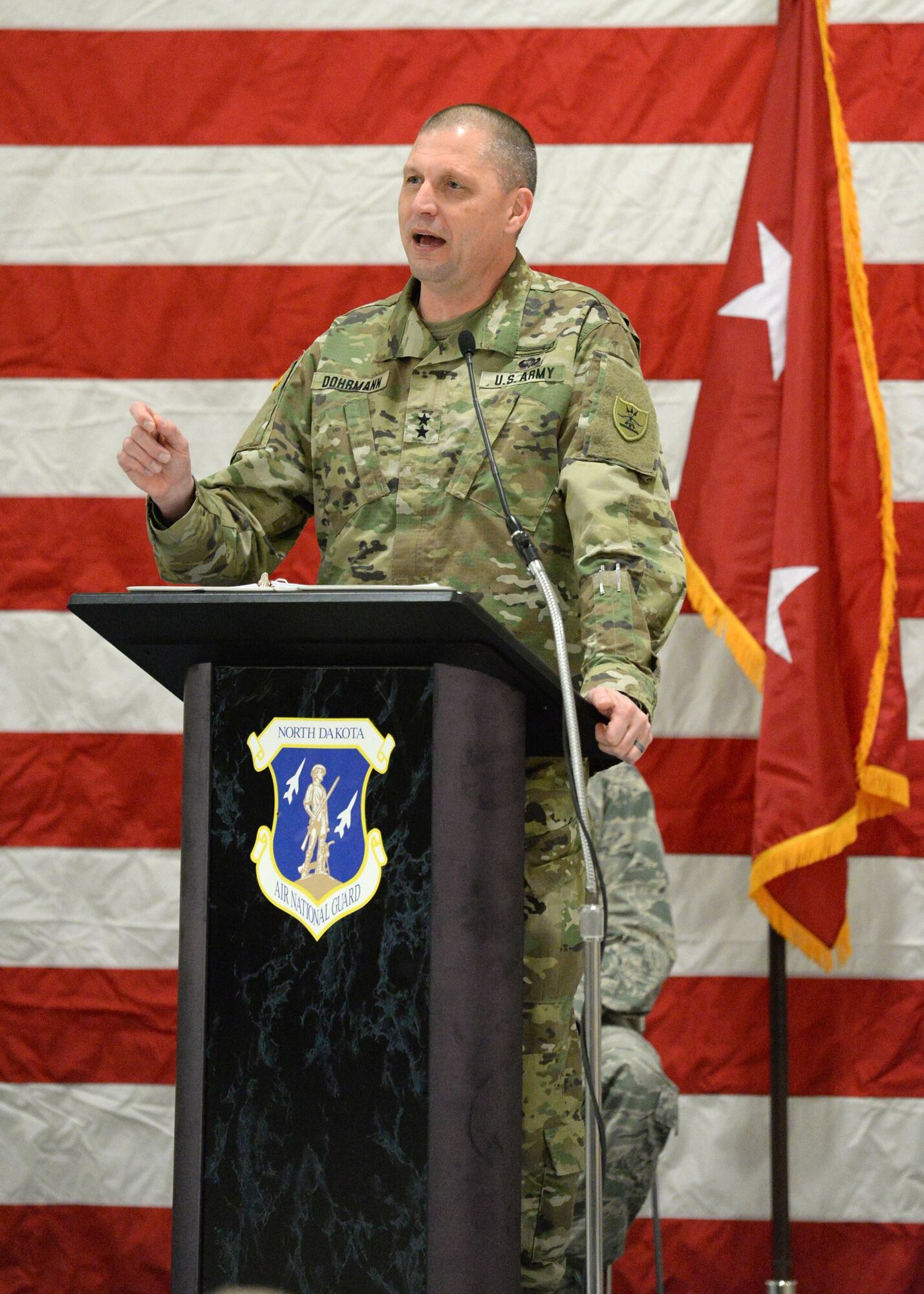 Maj. Gen. Al Dohrmann, the North Dakota adjutant general, speaks to a 119th Wing unit member formation and a gathering of civilian dignitaries gathered for a ceremony formally recognizing the unit with the Air Force Outstanding Unit Award at the North Dakota Air National Guard Base, Fargo, N.D., Jan. 6, 2017.